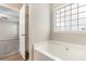 Relaxing soaking tub situated under a window at 7420 Bristol Cir, Douglasville, GA 30134