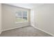 Bedroom featuring neutral carpet, one window and a white door at 7420 Bristol Cir, Douglasville, GA 30134