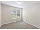 Bedroom with a plush carpet, a window with blinds, and neutral colors at 7420 Bristol Cir, Douglasville, GA 30134
