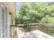 Wooden deck with railing surrounded by lush green trees at 7420 Bristol Cir, Douglasville, GA 30134