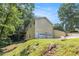 Two story home with garage and side deck set among lush green trees at 7420 Bristol Cir, Douglasville, GA 30134