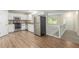 Open kitchen featuring stainless steel appliances, white cabinets, and hardwood floors at 7420 Bristol Cir, Douglasville, GA 30134