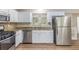 Bright kitchen featuring granite countertops, white cabinets and stainless steel appliances at 7420 Bristol Cir, Douglasville, GA 30134