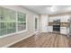 Bright kitchen features stainless steel appliances, wood floors, granite counters and large windows at 7420 Bristol Cir, Douglasville, GA 30134