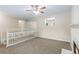 Upstairs loft area features a ceiling fan, neutral carpet and a fireplace with marble hearth at 7420 Bristol Cir, Douglasville, GA 30134