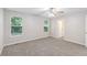 Main bedroom features large windows, neutral carpet, and a ceiling fan at 7420 Bristol Cir, Douglasville, GA 30134