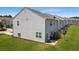 Rear view of townhouse featuring a grassy backyard and privacy fence at 161 Swindon Dr, Mcdonough, GA 30253