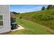 View of the townhouse's grassy backyard, patio area, and lush surroundings at 161 Swindon Dr, Mcdonough, GA 30253