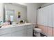 Bright bathroom featuring a white vanity, large mirror, and a shower with a decorative pink and white curtain at 161 Swindon Dr, Mcdonough, GA 30253