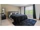 Comfortable bedroom with a plush rug and large windows for natural light at 161 Swindon Dr, Mcdonough, GA 30253