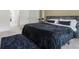 Another view of the comfortable bedroom with a plush rug and large windows at 161 Swindon Dr, Mcdonough, GA 30253