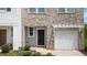 Close-up of home's exterior showing front door, garage, and landscaped entryway at 161 Swindon Dr, Mcdonough, GA 30253