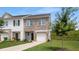 Charming brick and siding townhouse with a well-manicured lawn and attached garage at 161 Swindon Dr, Mcdonough, GA 30253