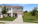 Charming brick and siding townhouse with a well-manicured lawn and attached garage at 161 Swindon Dr, Mcdonough, GA 30253