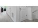 Upstairs hallway with neutral carpet leading to multiple bedroom and bathroom doors at 161 Swindon Dr, Mcdonough, GA 30253