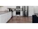 Well-lit kitchen featuring stainless steel appliances, granite countertops, and stylish wood flooring at 161 Swindon Dr, Mcdonough, GA 30253