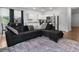 Open-concept living area featuring a spacious layout with a large sectional sofa, dining area, and stainless steel appliances at 161 Swindon Dr, Mcdonough, GA 30253