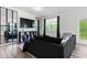 Stylish living room with modern decor, hardwood floors, and ample natural light at 161 Swindon Dr, Mcdonough, GA 30253