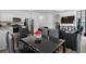 Open concept living space featuring modern decor and a dining area with a sleek black table at 161 Swindon Dr, Mcdonough, GA 30253