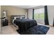 Cozy main bedroom with a plush bed, neutral tones, and a window offering natural light at 161 Swindon Dr, Mcdonough, GA 30253