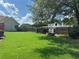 Large, green backyard with a covered barbeque and wooden privacy fence at 345 Annslee Circle Cir, Loganville, GA 30052