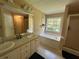 Double sink vanity, soaking tub, and walk-in shower in this bathroom at 345 Annslee Circle Cir, Loganville, GA 30052