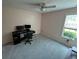 Bright bedroom with a ceiling fan, large window, and neutral carpet at 345 Annslee Circle Cir, Loganville, GA 30052