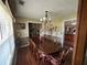 Charming dining room features a long wooden table, hardwood floors, and natural light streaming through the blinds at 345 Annslee Circle Cir, Loganville, GA 30052