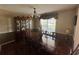 Dining room includes hardwood floors, a wooden table with chairs, a china cabinet, and a chandelier at 345 Annslee Circle Cir, Loganville, GA 30052