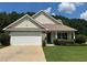 Charming single-story home featuring a two-car garage, well-maintained lawn, and traditional architectural details at 345 Annslee Circle Cir, Loganville, GA 30052