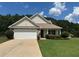 Charming single-story home featuring a two-car garage, well-maintained lawn, and traditional architectural details at 345 Annslee Circle Cir, Loganville, GA 30052