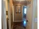 Bright hallway leading to laundry area, featuring wood floors and neutral paint at 345 Annslee Circle Cir, Loganville, GA 30052