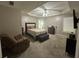 Cozy bedroom features carpeted floors, a seating area, and a tray ceiling with recessed lighting at 345 Annslee Circle Cir, Loganville, GA 30052