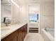 Bathroom featuring double sinks, vanity, bathtub, and walk-in access to the bedroom at 3630 Peachtree Ne Rd # 2706, Atlanta, GA 30326