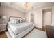 Elegant bedroom featuring a stunning chandelier, hardwood floors, and ensuite bathroom access at 3630 Peachtree Ne Rd # 2706, Atlanta, GA 30326