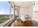 Bright dining area features floor-to-ceiling windows, city views, and stylish banquette seating at 3630 Peachtree Ne Rd # 2706, Atlanta, GA 30326