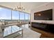 Bright living room features floor-to-ceiling windows with stunning views, modern chandelier, and sleek entertainment center at 3630 Peachtree Ne Rd # 2706, Atlanta, GA 30326