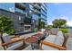 Outdoor terrace with a fireplace, comfortable seating, and lush landscaping with stunning views at 3630 Peachtree Ne Rd # 2706, Atlanta, GA 30326