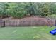 Large backyard featuring artificial turf, swingset and wooded views at 4335 Bellview Ln, Duluth, GA 30097