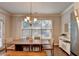 Well-lit dining area with a large window, modern light fixture, and a view of the backyard at 4335 Bellview Ln, Duluth, GA 30097