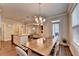 Open dining area with a large table, modern light fixture, and easy access to the kitchen and living room at 4335 Bellview Ln, Duluth, GA 30097