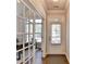 Bright entryway featuring wood floors, white trim, and a view of a study through glass doors at 4335 Bellview Ln, Duluth, GA 30097