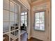 Bright entryway featuring wood floors, white trim, and a view of a study through glass doors at 4335 Bellview Ln, Duluth, GA 30097