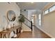 Hallway featuring wood floors, white trim, and a staircase with dark wood steps and railings at 4335 Bellview Ln, Duluth, GA 30097