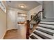 Hallway with stairway featuring wood floors, crown molding, and a view to the living room at 4335 Bellview Ln, Duluth, GA 30097