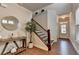 Hallway featuring wood floors, white trim, and a staircase with dark wood steps and railings at 4335 Bellview Ln, Duluth, GA 30097