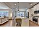 Beautiful kitchen with island, stainless appliances and seamless connection to the living room at 4335 Bellview Ln, Duluth, GA 30097