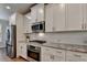 Elegant kitchen with stainless steel appliances, white cabinets, and granite countertops at 4335 Bellview Ln, Duluth, GA 30097