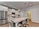 Bright kitchen boasts white cabinets, granite countertops, and stainless steel appliances at 4335 Bellview Ln, Duluth, GA 30097