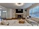 Comfortable living room showcases a stone fireplace, built-in shelves, and a large sectional sofa with natural light at 4335 Bellview Ln, Duluth, GA 30097